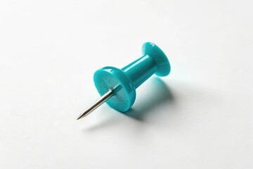 Small cyan colored sewing push pin with a subtle shadow effect isolated on white background, cyan pushpin, textile decoration, thread tool