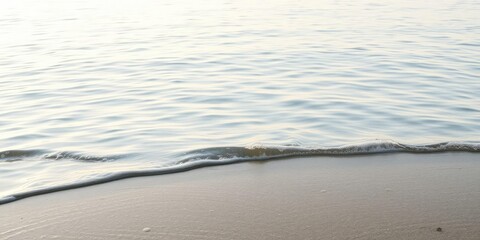 Softly lapping water's edge on a serene lake surface, with gentle ripples and bubbles on the calm white water, tranquil atmosphere, gentle lapping, serene landscape