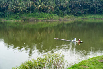 fisherman on bamboo raft at the lake
