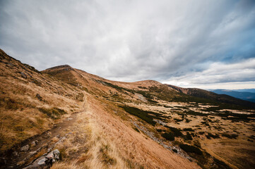 Mountain Trail Under Cloudy Sky