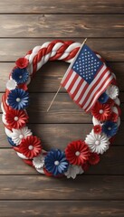 Obraz premium A beautifully crafted patriotic wreath featuring red, white, and blue flowers and a tiny American flag, ideal for July 4th and festive home decor.