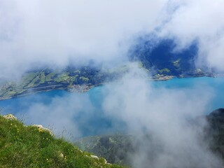 Magic photo of a lake reflecting the mountains during a hike in the Swiss Alps