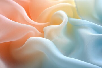 Soft silk fabric in gradient colors of peach and blue flows gracefully, creating a delicate texture and allure