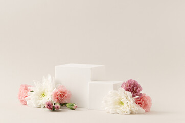Beauty Cosmetics Product Presentation Scene made with Two White Cube Podiums and Natural Flowers on White Background. Studio Photography.