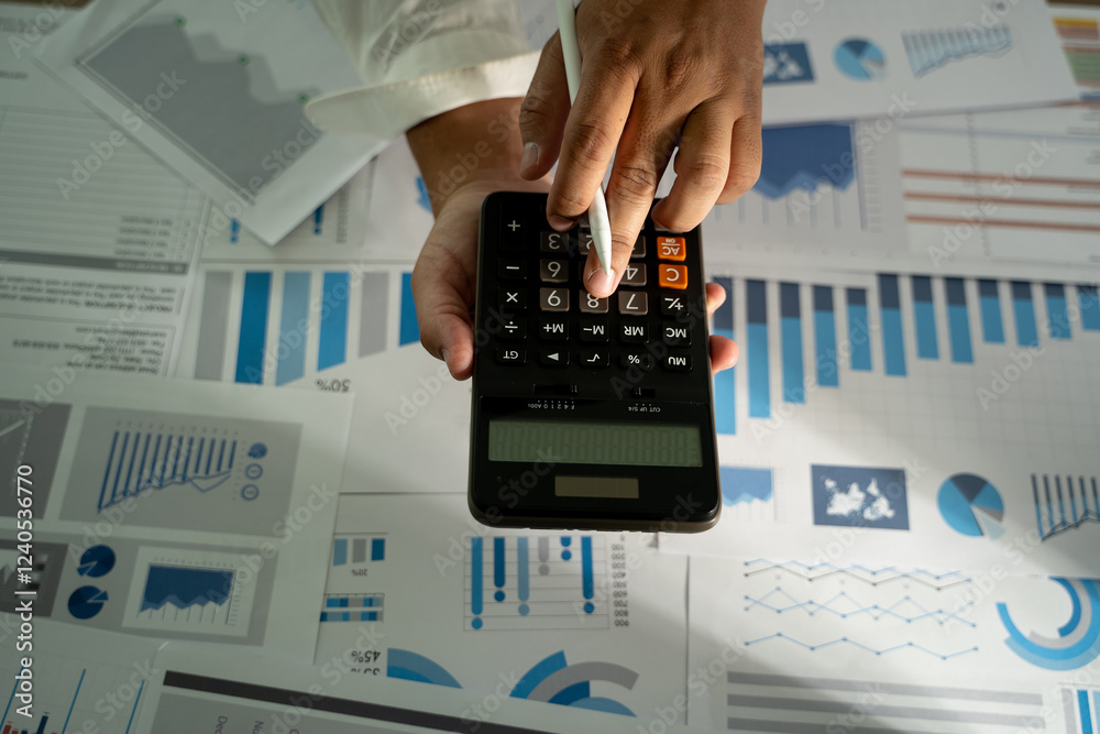 Wall mural man hand using calculator finance budgeting and tax financial cost calculation statistical data anal