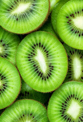 The image showcases a vibrant and fresh close-up of sliced kiwi fruits. The bright green flesh, tiny black seeds, and radial symmetry create a visually appealing pattern.