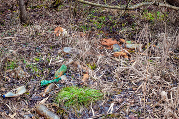 Various kinds of trash waste objects a lot floating in the pond mixed with aquatic plants