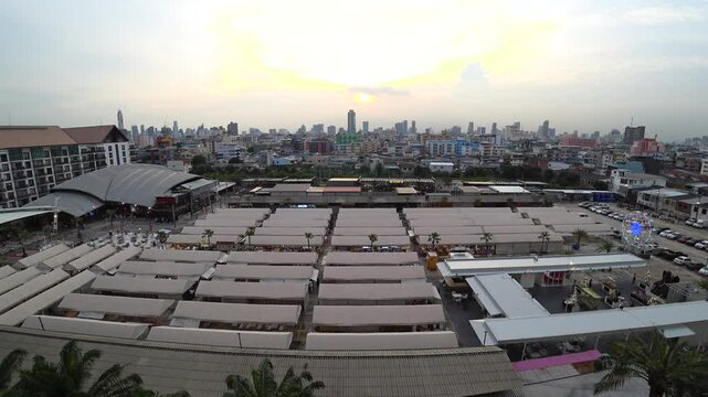 BANGKOK, THAILAND - AUGUST 2024 : View of shops and food stalls at &ldquo;The One Ratchada night market&rdquo; in sunset.