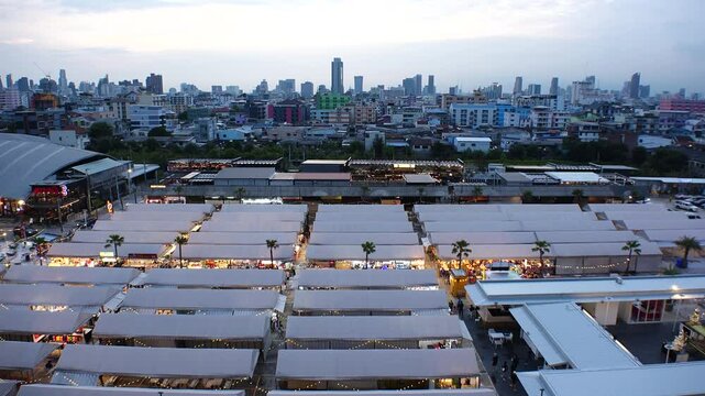BANGKOK, THAILAND - AUGUST 2024 : View of shops and food stalls at &ldquo;The One Ratchada night market&rdquo; in sunset.
