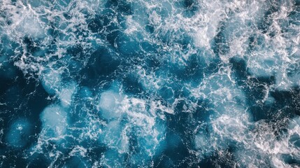 Obraz premium Turquoise Waves and White Foam Over Deep Blue Ocean Water Surface