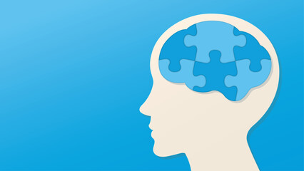 青いパズルのピースでできた脳と横顔のイラスト　青い背景