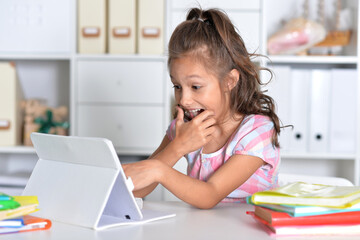 Portrait of girl studing with tablet at classroom