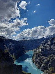 Magic photo of a lake reflecting the mountains during a hike in the Swiss Alps 