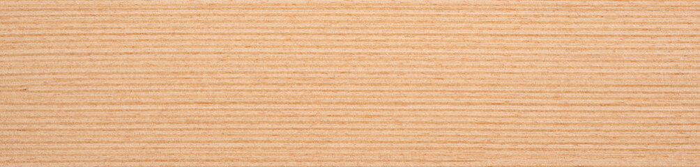 Fototapeta premium Warm beige and soft sandy hues cascade across the smooth surface of light oak veneer