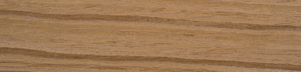 Fototapeta premium The warm swirls of teak veneer weave a captivating narrative in rich amber, caramel, and mahogany tones