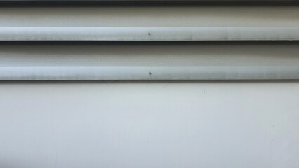 Obraz premium White cement wall with silver zinc panels, Factory wall, Texture and background image of white painted wall.