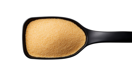 Close-up of a black scoop filled with golden granulated sugar on a dark backdrop.