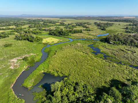 Aerial view of lush wetland and river surrounded by expansive grassland, Miranda, Brazil.