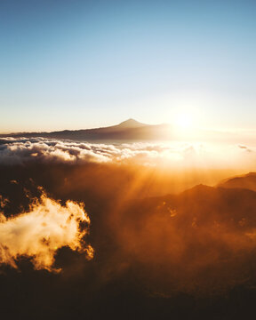 Aerial view of majestic sunset over the mountain clouds at Monumento Natural de Los Roques, Parque Nacional de Garajonay, San Sebastian de La Gomera, Spain.