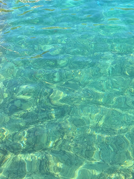 Green transparent sea water surface.
