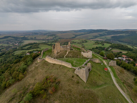Aerial view of the beautiful Branc castle ruin surrounded by a scenic landscape of rolling hills and greenery, Podzamok, Slovakia.
