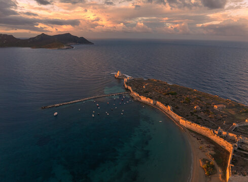 Aerial view of ancient castle ruins by the sea at sunrise, Methoni, Greece.