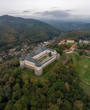 Aerial view of cerveny kamen castle surrounded by beautiful green forest and hills, Casta, Slovakia.