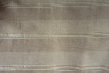 Surface of light beige striped cotton and polyester fabric