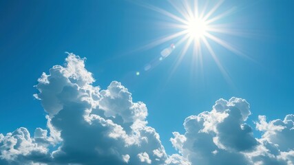 Bright sunny sky with fluffy white clouds and a radiant sun