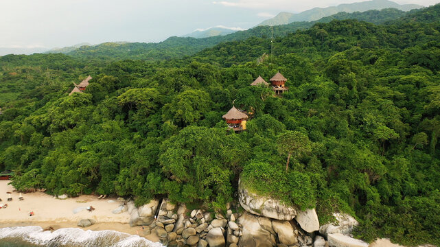 Aerial view of tayrona beach with lush jungle and serene ocean waves, Santa Marta, Colombia.