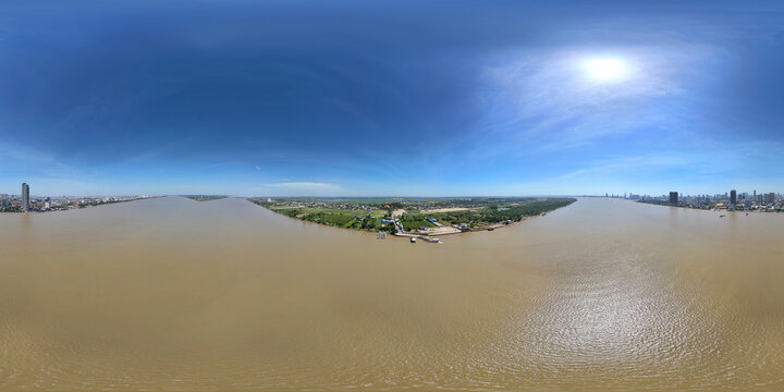 Aerial view of tranquil river and cityscape under a clear sky, Svay Chrum, Cambodia.