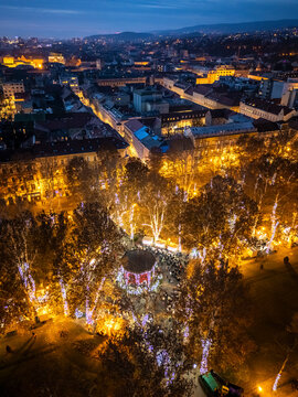 Aerial view of zrinjevac park illuminated by festive lights during the christmas market, zagreb, croatia.