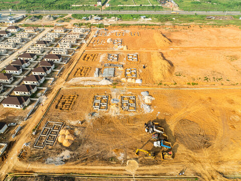 Aerial view of construction site with excavators and uncompleted buildings in greater taf city, port harcourt, nigeria.