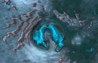 Aerial view of beautiful glacier lake with turquoise ice formations and serene landscape, Oraefasveit, Iceland.