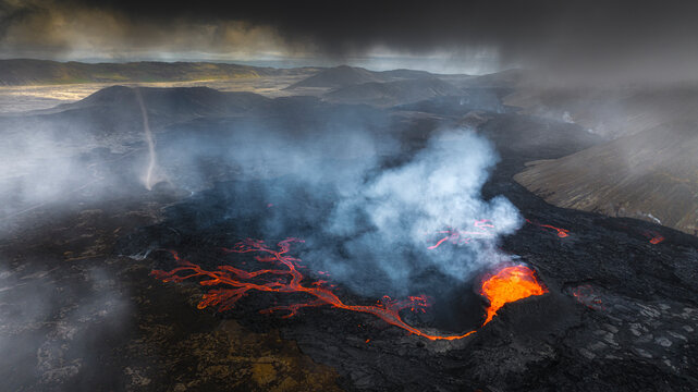 Aerial view of little hruttur volcano with lava and smoke in a scenic volcanic landscape, Grindavik, Iceland.