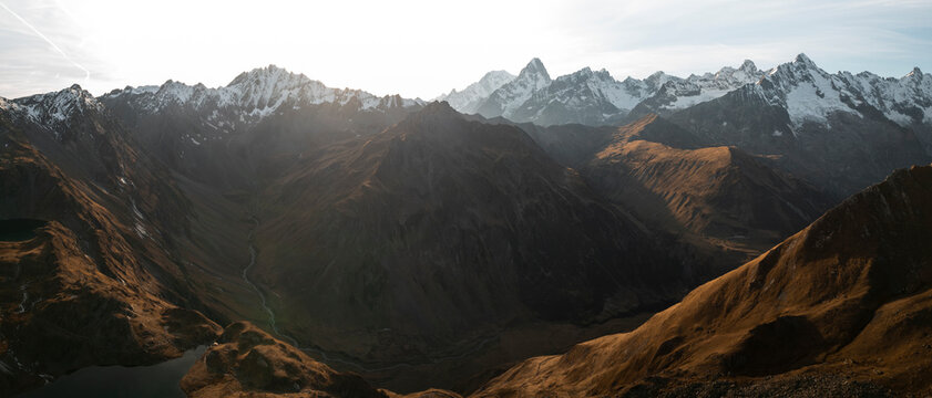 Aerial view of lacs de fenetre in autumn with mountains and river at sunset, la fouly, switzerland.