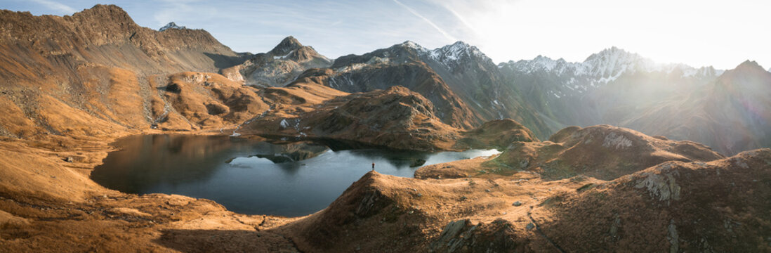 Aerial view of lacs de fenetre surrounded by majestic mountains at sunset, La Fouly, Switzerland.