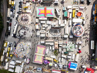 Aerial view of colorful funfair with bustling rides and lively attractions, Graz, Austria.