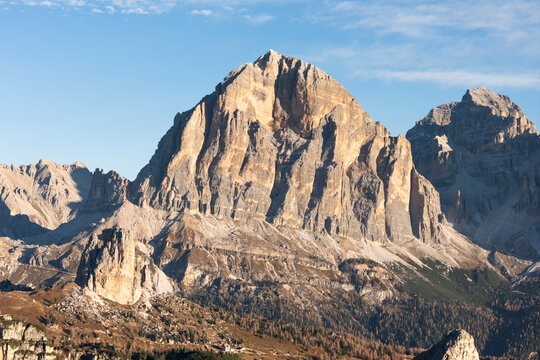 Aerial view of the majestic Tofana di Rozes mountain with rugged rock formations and clear sky, Cortina d'Ampezzo, Italy.