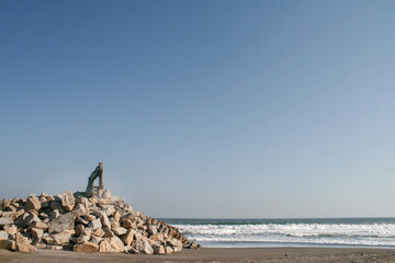Excavator On Rock Pile At Beach Breakwater Construction Site, Yogyakarta 2011