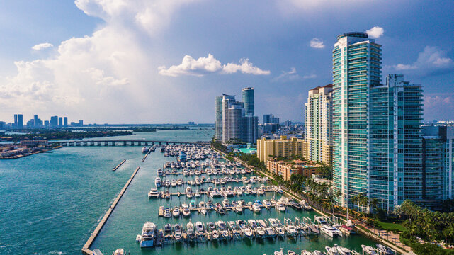 Aerial view of vibrant high rise buildings and marina with boats on beautiful water, Miami Beach, United States.