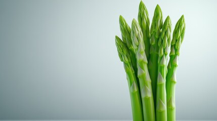 Fresh green asparagus spears displayed against a minimalistic background.