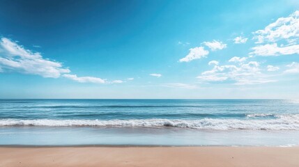 Obraz premium Wide expanse of ocean waves crashing on golden sandy beach under bright blue sky and fluffy white clouds. Generative AI