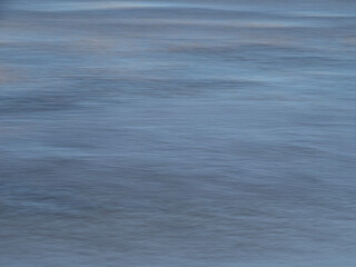 Blue water surface with intentional camera movement