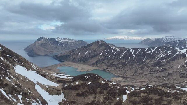 Aerial view of ball beach and morris cove surrounded by rugged mountains and serene water, Unalaska, United States.