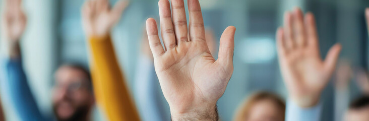 Hands raised in group setting, indicating participation and engagement