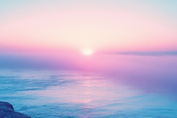 Naklejka premium Misty sunrise over calm water creates a tranquil atmosphere in early morning light