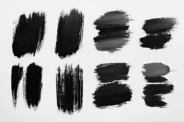 Abstract black and gray paint strokes on a white background showcasing different brush techniques