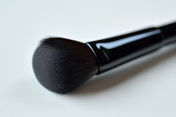 Obraz premium Brush designed for makeup application with a soft, rounded head on a light background