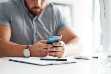 Man, phone and hands for planning in office, gym consultant and email response to clients. Male person, professional salesman and typing feedback to business contact in workplace, book and notes